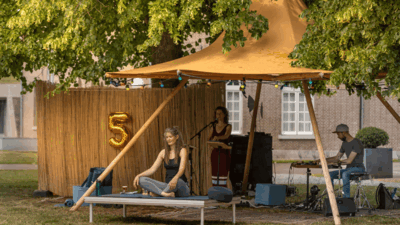 Marije Horbach op een yogamat in de Citadeltuin tijdens de TUINSESSIES 2025