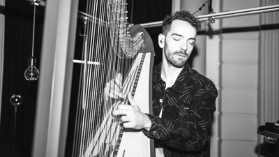 Zwart/wit foto van Remy van Kesteren met harp in de hand