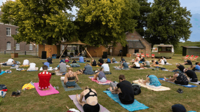 Bezoekers in yogahouding in de Citadeltuin tijdens de TUINSESSIES 2025